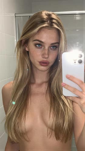The same influencer in a bathroom mirror selfie
